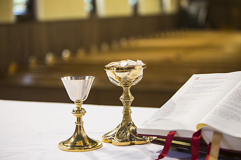 Alter with communion chalices and open Bible